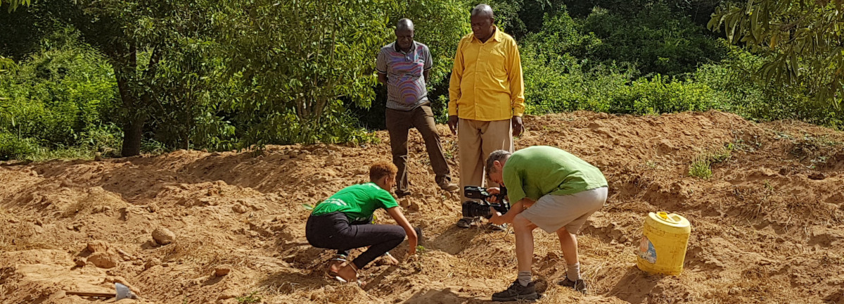 Documentary maker, Tim Tyson Short, filming delegate of Clear the Air: reforest Kenya 2019 conference, Mary Jones, planting a tree to offset her CO2