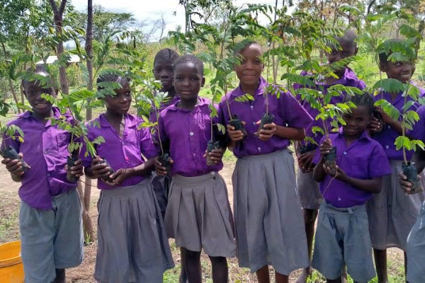 Children planting trees with The Word Forest Organisation