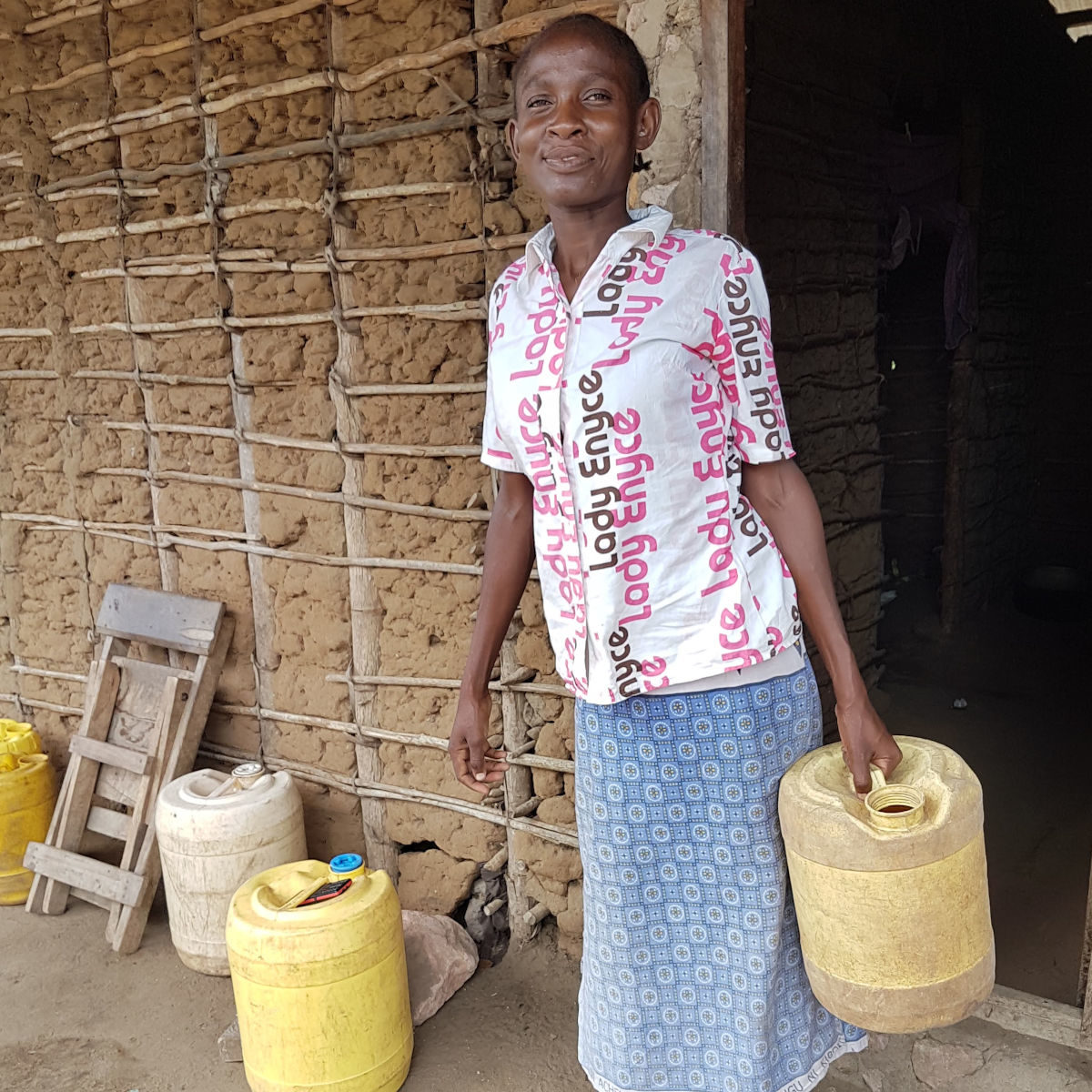 Woman carrying 20l water container