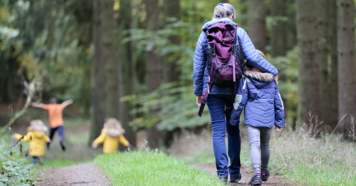 Woman with blue denim jeans and black jacket walking with child by Juliane Liebermann on Unsplash