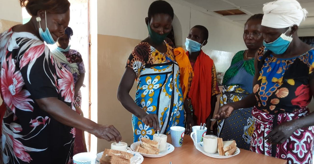 Mothers of the Forest sharing tea and sandwiches