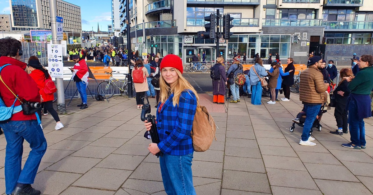 Person in blue outside COP 26