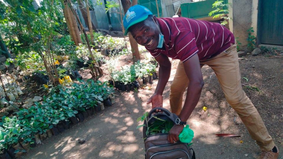 Solomon Owiti with a bag of saplings