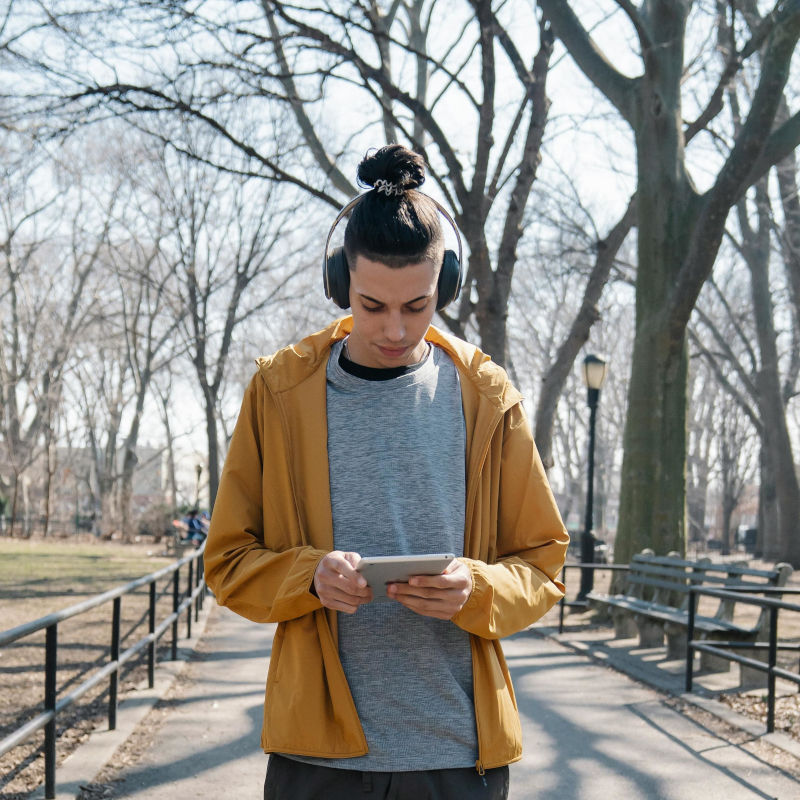 Person listening to music in a park by Eren Li on Pexels